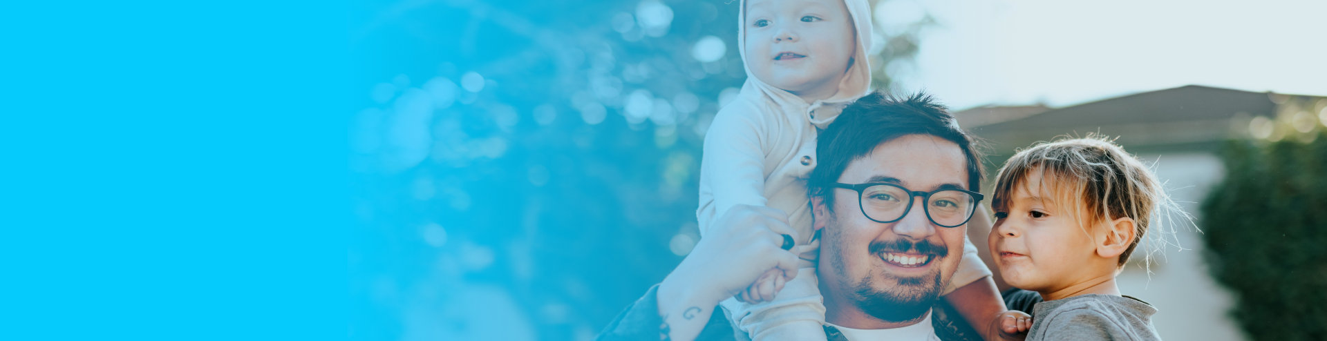 A photo of a man and two children with a blue background